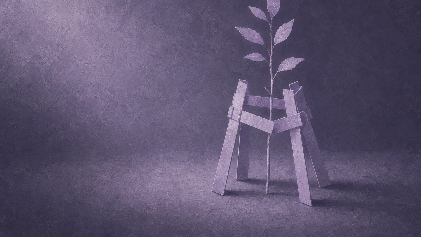 A small scaffold of folded paper struts supporting a slender paper sapling on a dusty-violet surface