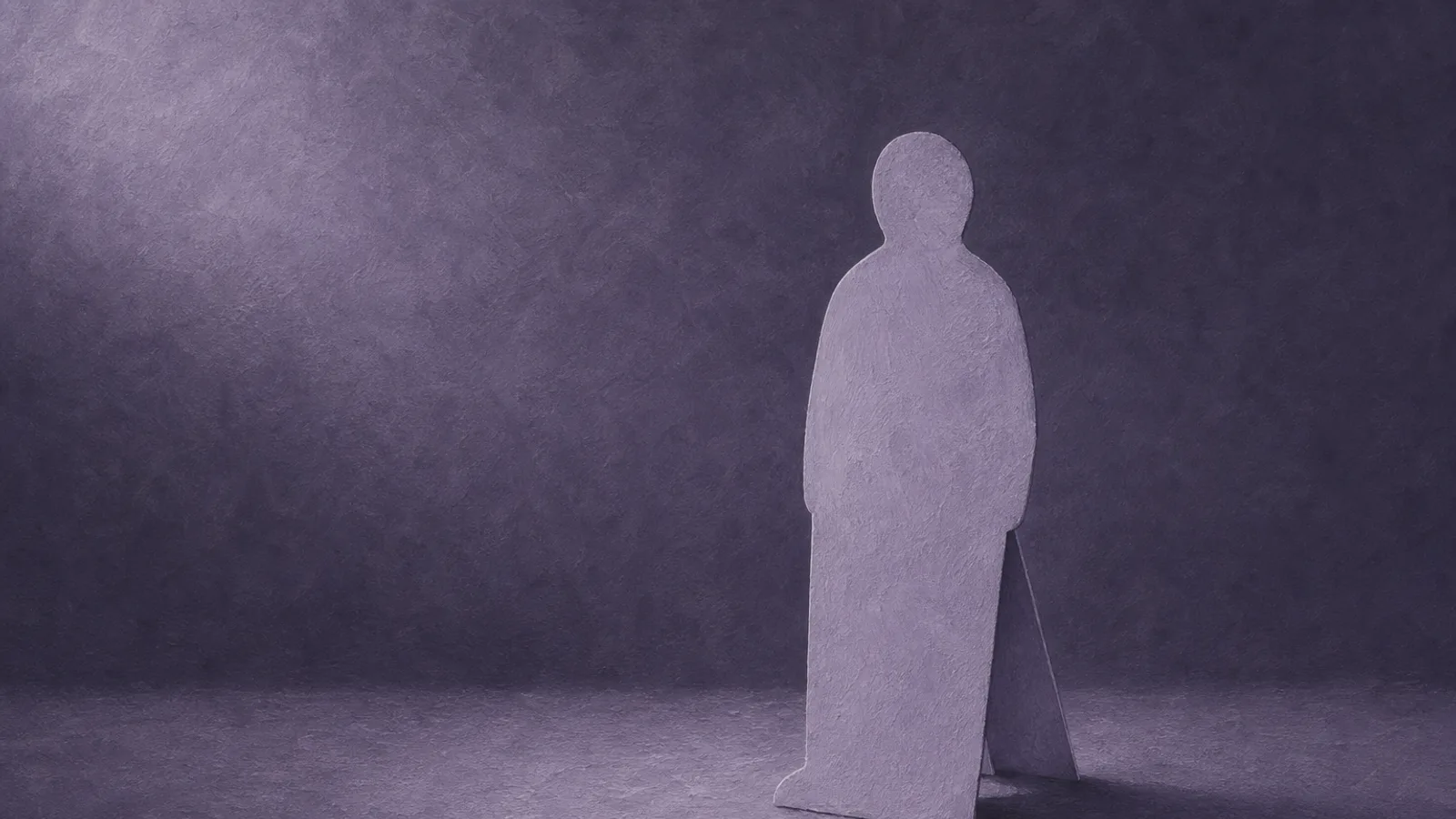 A flat propped-up paper cut-out of a figure standing where a real companion should be, on a dusty-violet surface