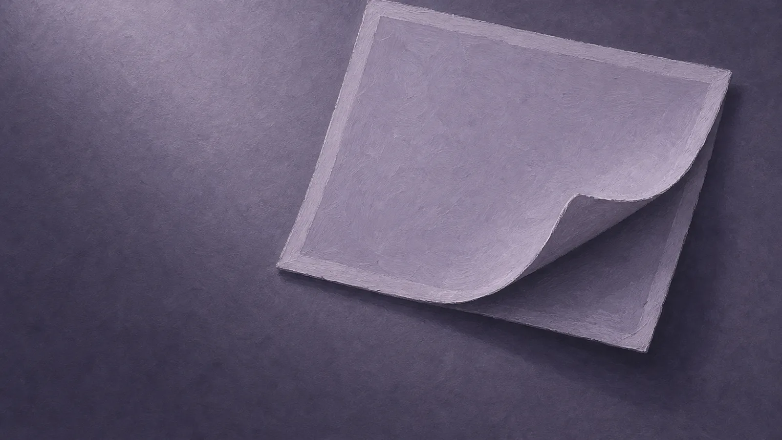 A paper photo-card on a surface, its printed face peeling away from the backing