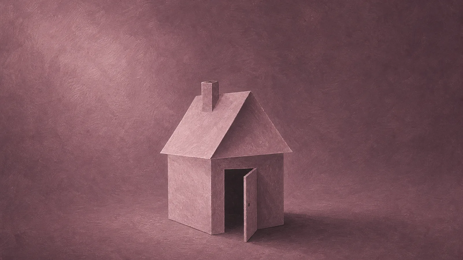 A small paper house with its door left standing open on a plain surface