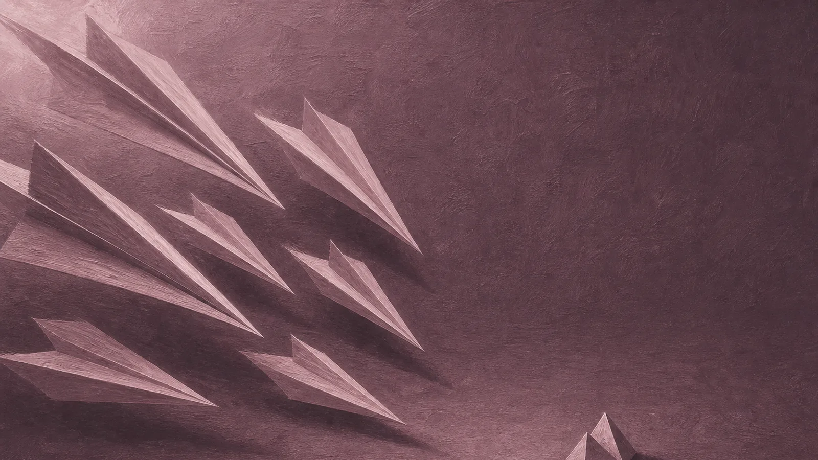 A cluster of sharp folded paper darts all aimed at one small paper shape on a plain surface