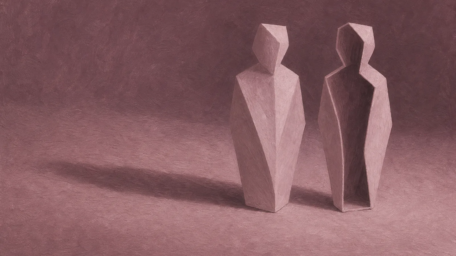 A folded paper figure standing beside an exact paper copy of itself on a plain surface